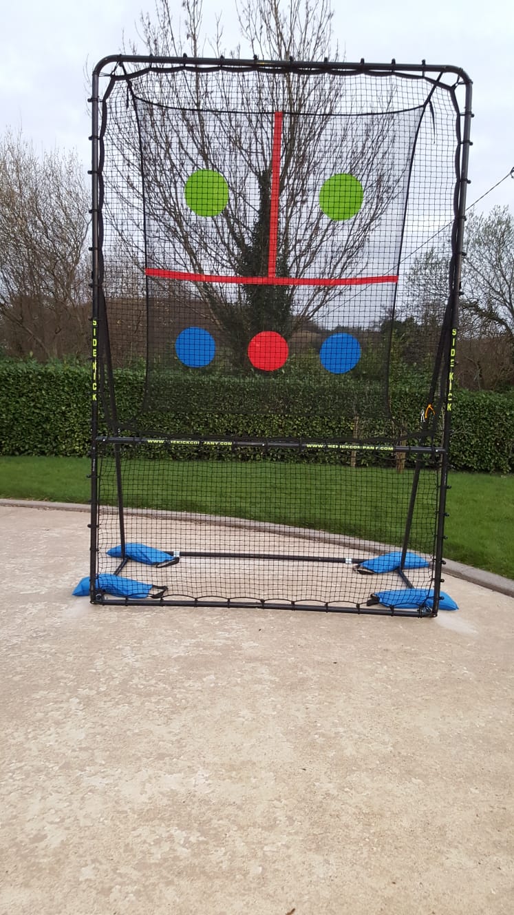 SkillMaster Ball Rebounder postioned in homes backyard